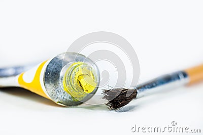 Bright yellow Acrylic paint, extruded from the tube. On a white Stock Photo