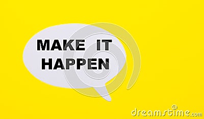 On a bright yellow background, white paper with the words MAKE IT HAPPEN Stock Photo