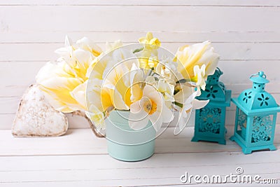 Bright yellow daffodils and tulips flowers, heart and lanterns Stock Photo