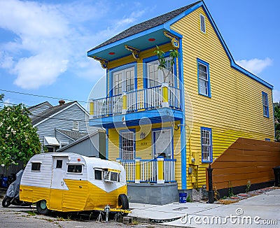 Bright Yellow Historic Home and Two Tone Trailer in the Marigny Neighborhood of New Orleans Editorial Stock Photo
