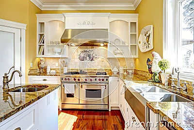 Bright yellow kitchen room with granite tops Stock Photo