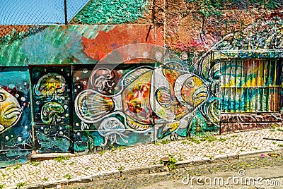 Brightly colored graffiti on building exteriors in Lisbon, Portugal Editorial Stock Photo