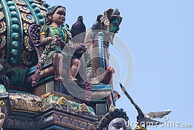 Brightly colored Hindu-themed statues outside of Batu Caves Stock Photo