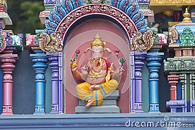 Brightly colored Hindu-themed statues outside of Batu Caves Stock Photo