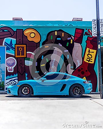 From old to new, Porsche sports cars parked near an art mural in a downtown art Miami district. Editorial Stock Photo