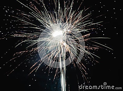 Brightly colorful explosive fireworks light up the night sky at New Year`s eve celebrations. Happy New Year 2017 and holidays Stock Photo
