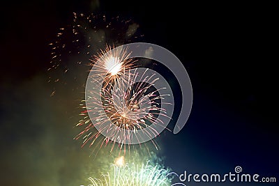 Brightly colorful fireworks of various colors in the night sky Stock Photo