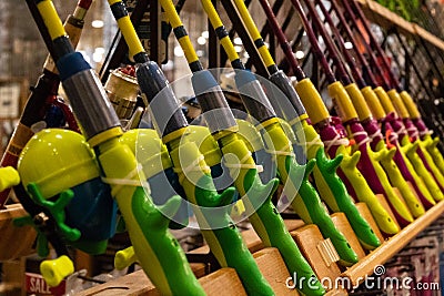 Brightly coloured fishing rods on display in world-renowned sporting goods store Stock Photo