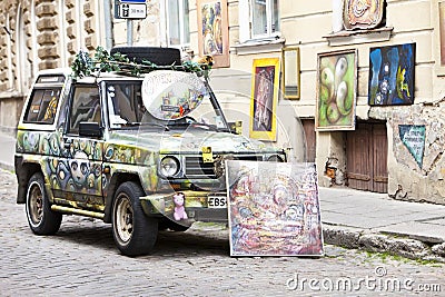 Brightly decorated car advertizes an input in art gallery in the Old city on June 16, 2012 in Tallinn, Estonia Editorial Stock Photo