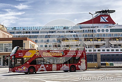 Brightly decorated sightseeing double-decker open top bus in Cad Editorial Stock Photo
