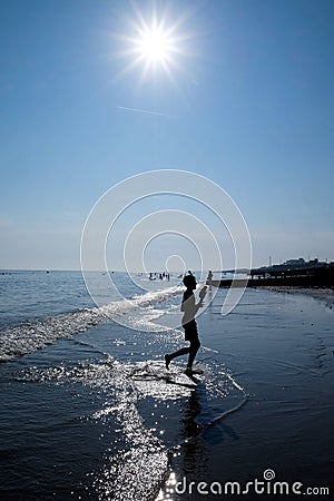 Boy on the waters edge of Brighton beach Editorial Stock Photo