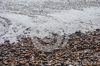 Brighton beach - waves and pebbles on a sunny day. Stock Photo