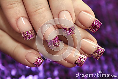 Brilliant French manicure with lilac and golden small glitters Stock Photo