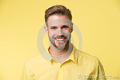 Brilliant smile. Man smiling face posing confidently yellow background. Man shop consultant looks cheerful confident and Stock Photo