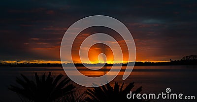 Brilliant sunrise through cloudy sky Stock Photo