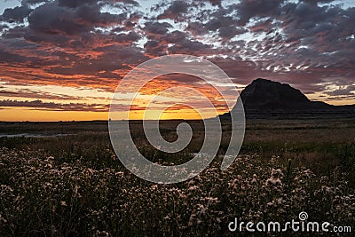 Brilliant Sunrise Light Over Badlands Field Stock Photo