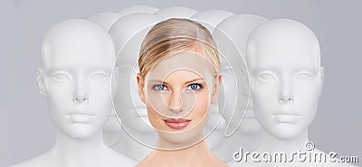 Bring your beauty to life. A young woman standing amongst a group of mannequins. Stock Photo