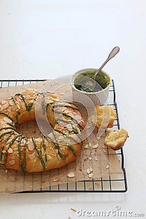 Brioche almon topped and glazed matcha chocolate Stock Photo