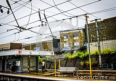 Brisbane Australia - Bowen Hills train station with commuters waiting in the rain Editorial Stock Photo