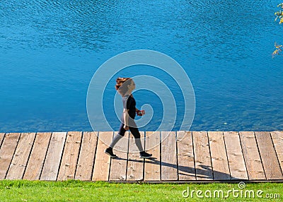 A brisk walk on the waterfront on a sunny afternoon Editorial Stock Photo