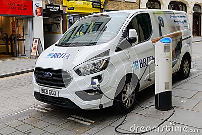 Brita electric vehicle being rechaged on London street Editorial Stock Photo