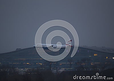 British Airways Airbus Landing at night at Heathrow Airport Editorial Stock Photo