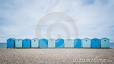 British blue beach houses near Charmouth in Dorset, UK Stock Photo