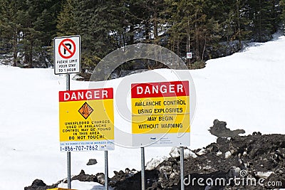 View of sign on Trans-Canada Highway `Danger. Avalanche Control using Explosives. Editorial Stock Photo