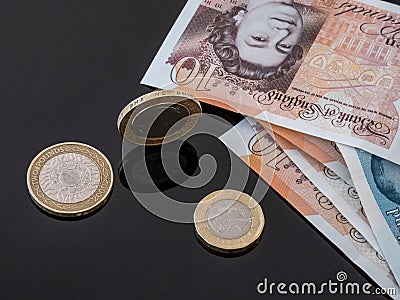 British currency notes and coins on the glass table. Editorial Stock Photo