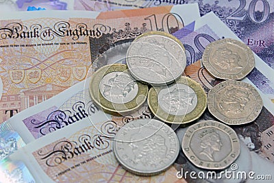 Money investments British currency sterling Notes and coins Editorial Stock Photo