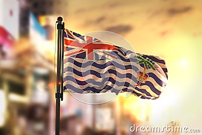 British Indian Ocean Territory Flag Against City Blurred Background At Sunrise Backlight Stock Photo