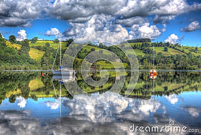 British Lake District England UK at Ullswater with sailing boats mountains and clouds on beautiful still summer day Stock Photo