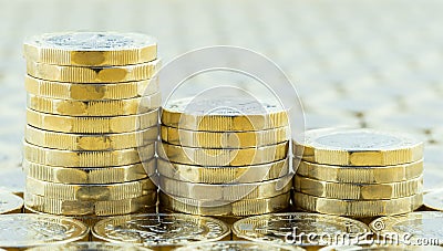 British money, three pound coins descending stacks. Stock Photo