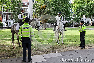 28 7 2022: British policeman on horseback patrolling at Soho Square, London, preparing a major event, guarding the city Editorial Stock Photo