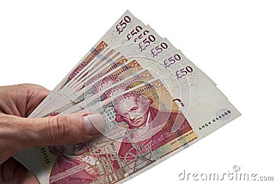 British pounds in hand. Several banknotes of United Kingdom Editorial Stock Photo