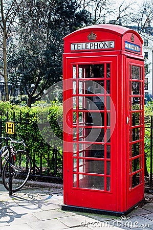 British Telecoms telephone box near a park in London Stock Photo