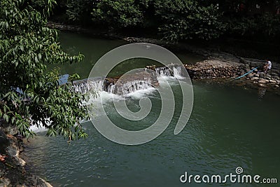 A broad dam spans across the river Editorial Stock Photo