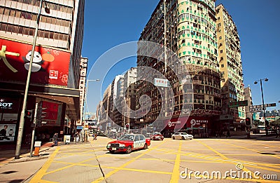 Broad street with skyscrapers and fast cornering taxi cab of Hong Kong Editorial Stock Photo