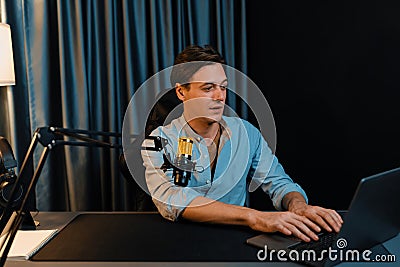 Broadcaster talking on live application searching on laptop. Pecuniary. Stock Photo
