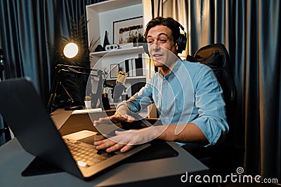 Broadcaster talking on live application searching on laptop. Pecuniary. Stock Photo