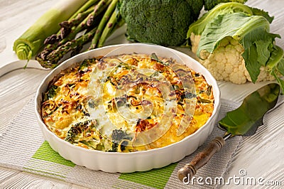 Broccoli, cauliflower and asparagus casserole with eggs and cheese, keto diet dish. Stock Photo