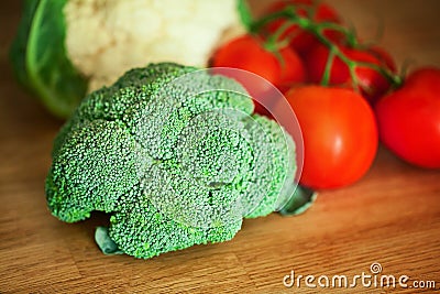 Broccoli, Cauliflower, tomato on the wooden board Stock Photo