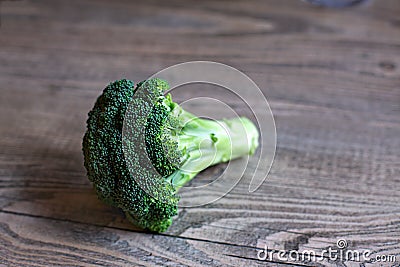 Broccoli Floret on Wood Table Stock Photo