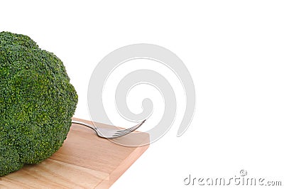 Broccoli with fork on cutting board Stock Photo