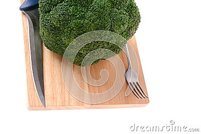 Broccoli with fork and knife on the cutting board Stock Photo