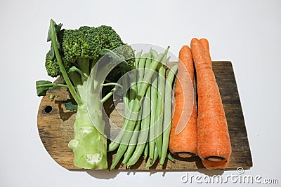 Broccoli, greenbeans and carrot on the wooden board Stock Photo