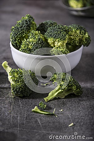 Broccoli pieces on a granite tabletop. Cooking preparation. Stock Photo