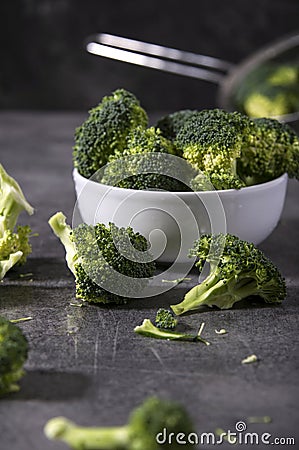 Broccoli pieces on a granite tabletop. Cooking preparation. Stock Photo