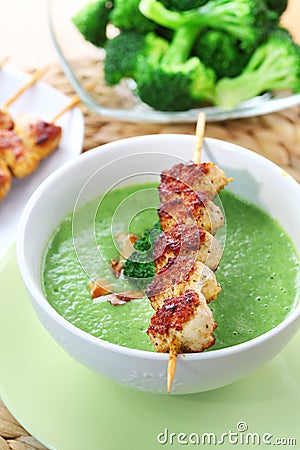 Broccoli soup with skewered chicken Stock Photo