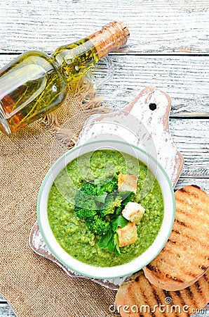 Broccoli, spinach cream soup in a bowl with toasted bread. Green soup. Dietary food. Stock Photo